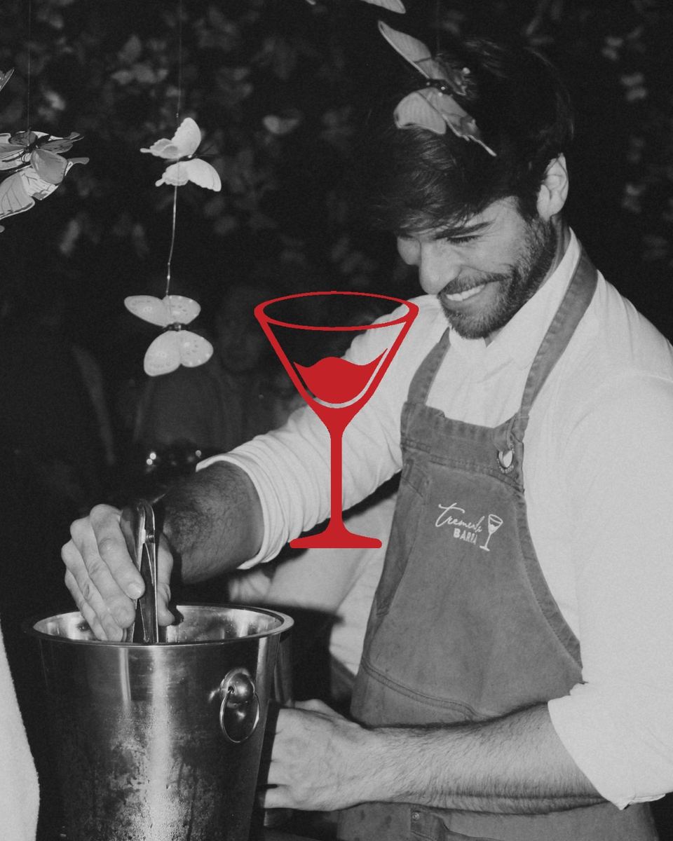 Tremenda Barra — bartender con copa roja, foto en blanco y negro